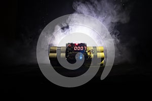 Image of a time bomb against dark background. Timer counting down to detonation illuminated in a shaft light shining through the d