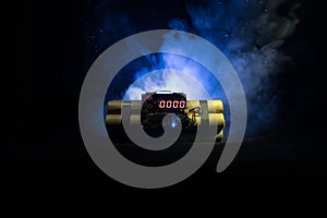 Image of a time bomb against dark background. Timer counting down to detonation illuminated in a shaft light shining through the d