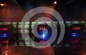 Image of a time bomb against dark background. Timer counting down to detonation illuminated in a shaft light shining through the d