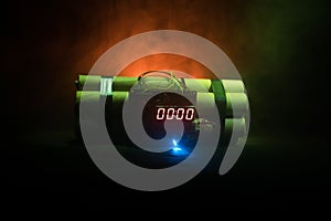 Image of a time bomb against dark background. Timer counting down to detonation illuminated in a shaft light shining through the d