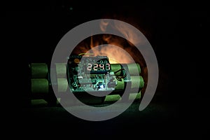 Image of a time bomb against dark background. Timer counting down to detonation illuminated in a shaft light shining through the d