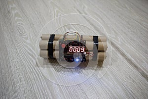 Image of a time bomb on floor. Timer counting down to detonation illuminated in a shaft light shining through the darkness