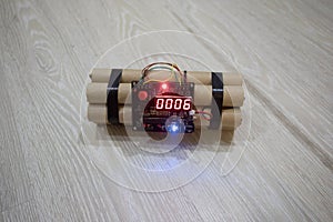 Image of a time bomb on floor. Timer counting down to detonation illuminated in a shaft light shining through the darkness