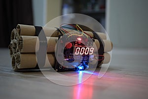 Image of a time bomb on floor. Timer counting down to detonation illuminated in a shaft light shining through the darkness