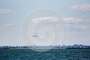 Image of Toronto lake with buildings, downton. Plane arriving to Toronto Island airport