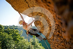 Image of tourist man in helmet clambering up