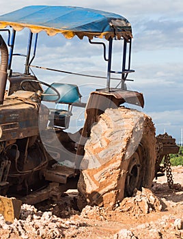 The image of the tractor in the mud