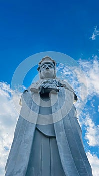 Image of a traditional Japanese Buddha statue, illuminated in the warm morning light