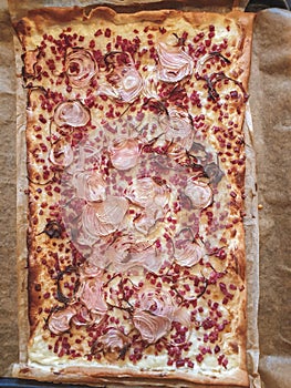 Image of Traditional Tarte flambee with creme fraiche, cheese, onion and bacon. Top down view, Flat lay