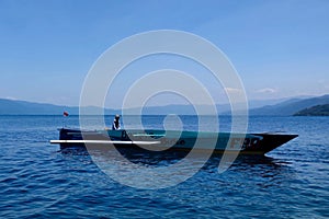 Tranquil scene with fishing boat on Lake Matano