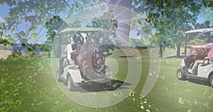 Image of trees over golf carts on golf course