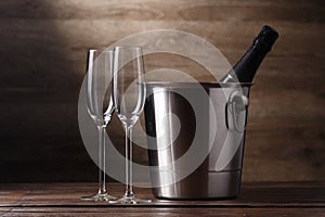 Image of two empty wine glasses, bottle of champagne