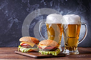 Image of two hamburgers, glasses with beer