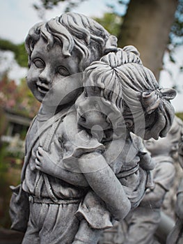 Image of two kids in the park, stone, close-up