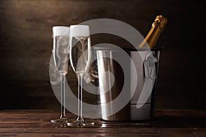 Image of two wine glasses with sparkling wine, iron bucket