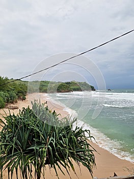 The image of untouched beach in Blitar called White Sand Beach Pasetran Gondo Mayit