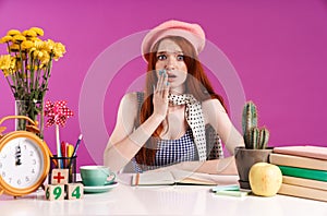 Image of uptight teenage girl screaming while studying with exercise books