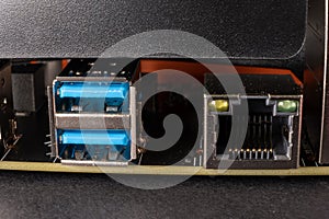 An image of USB connectors on a computer motherboard backplate, arranged in a row of USB Type 2 and rj45 net connector