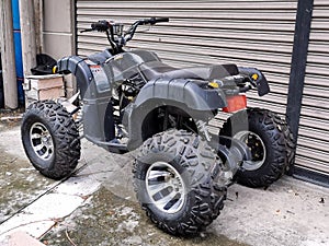 Image of used black in color all terrain vehicle. Selective focus.