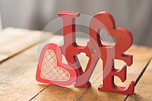 Image of Valentine`s Day, symbols of love and letters, on a background of wooden boards.