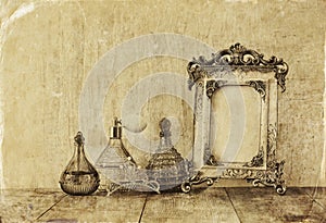 Image of victorian vintage antique classical frame, jewelry and perfume bottles