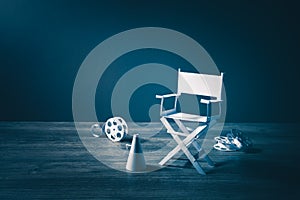 Image with vintage texture of a Director chair and movie items