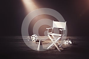 Image with vintage texture of a Director chair and movie items