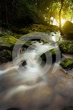 An Image of waterfall in the morning with sun rays