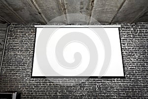 Image of white projector screen on gray brick wall photo