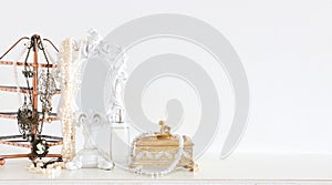 Image of white vintage mirror and pearls over wooden table. For mockup, can be used for photography montage