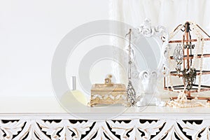 Image of white vintage mirror and pearls over wooden table. For mockup, can be used for photography montage