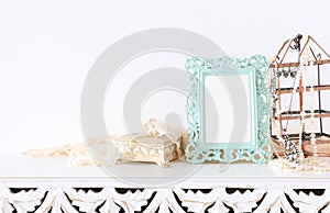 Image of white vintage mirror and pearls over wooden table. For mockup, can be used for photography montage