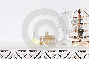 Image of white vintage mirror and pearls over wooden table. For mockup, can be used for photography montage