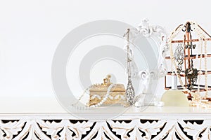 Image of white vintage mirror and pearls over wooden table. For mockup, can be used for photography montage