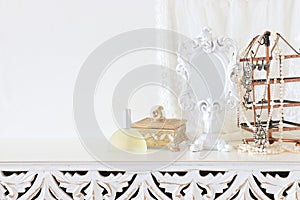 Image of white vintage mirror and pearls over wooden table. For mockup, can be used for photography montage