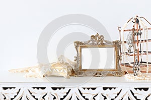 Image of white vintage mirror and pearls over wooden table. For mockup, can be used for photography montage