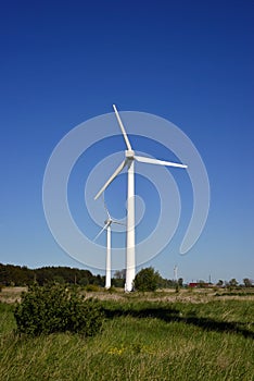 An image of windturbine generator in the blue sky background