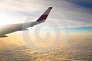 Image of wing of airplane and window.