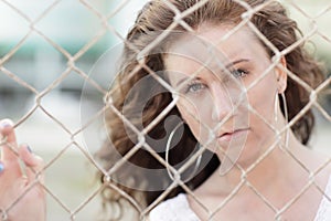 Image of a woman behind a fence