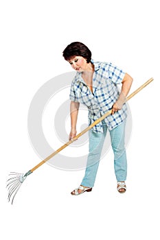 Image of woman farmer with rakes in hands
