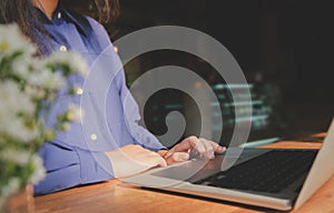 Image of woman hands using / typing on laptop computer selected focus on keyboard