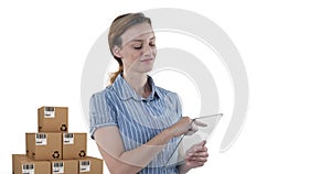 Image of woman holding transparent interactive tablet with stacks of boxes on white background