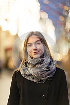 Image of woman outside in city at evening