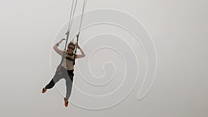 Image of a woman parachutist in casual clothing smiling.