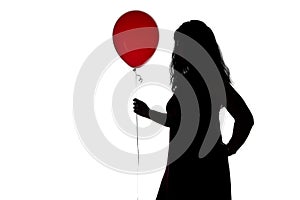 Image of woman's silhouette with red balloon