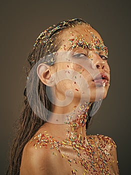 Image of woman with sprinkle candy face.