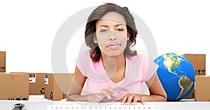 Image of woman typing on computer keyboards with globe stacks of boxes on white background