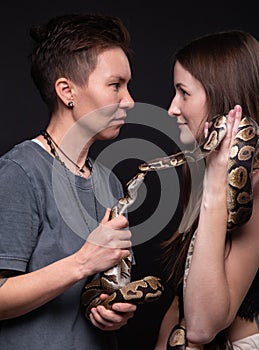 Image of women with two kissing snakes
