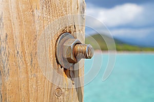 Image of the wood, the bolt, nut in the pier at sea .