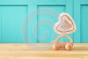 Image of wooden car with heart on the roof, present for dad. Father`s day concept